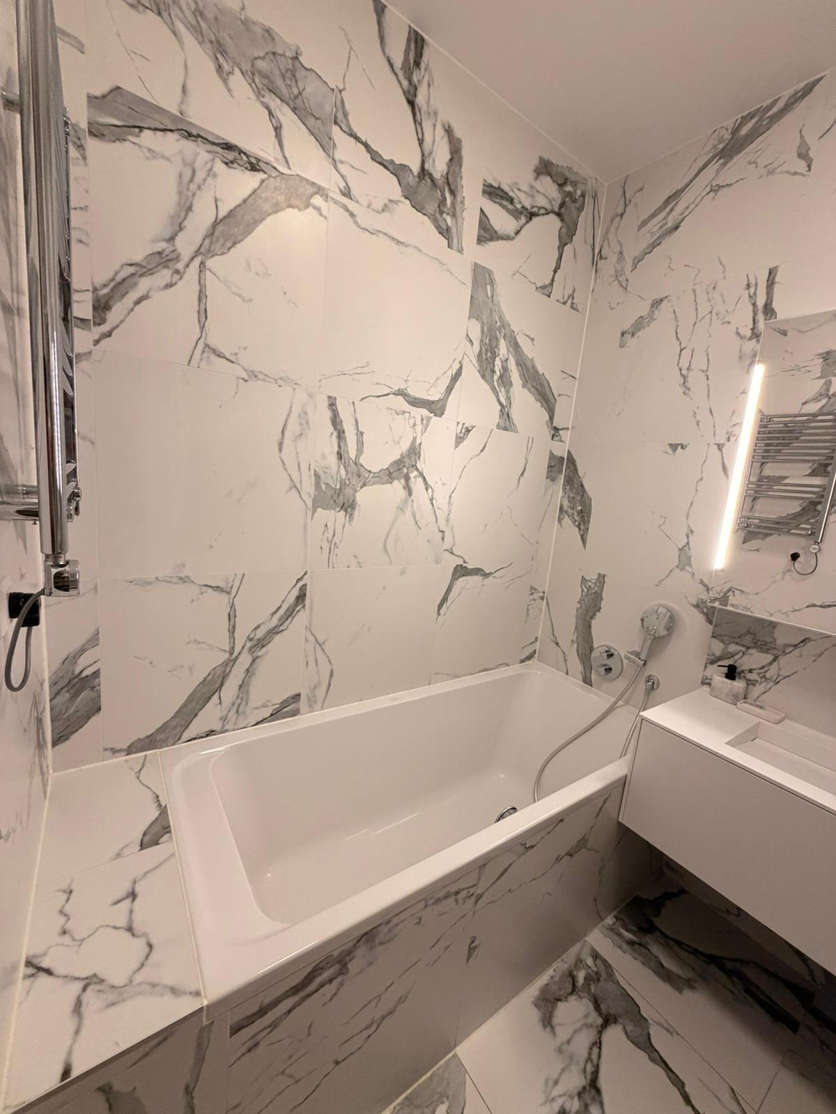 Shower tub, tiles, sink.