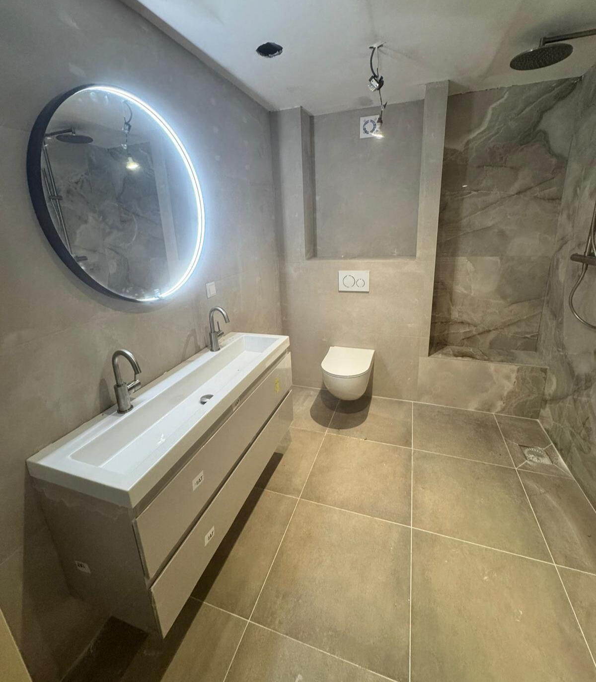 Sink, mirror, toilet, tiles.