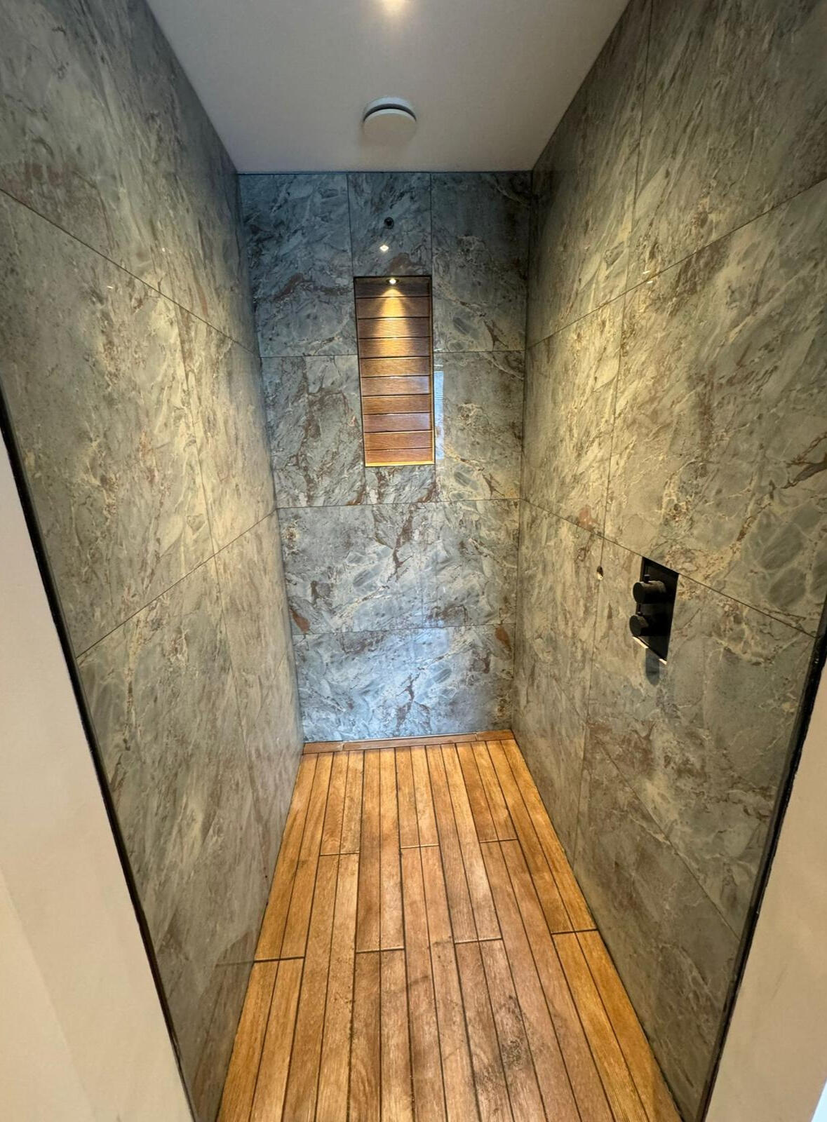 Shower cabin, tiles, wooden floor.